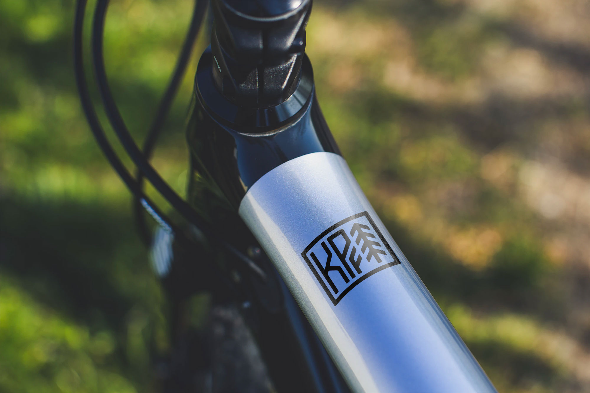 Kale Poland Fitness monogram decal applied to the silver frame of a mountain bike