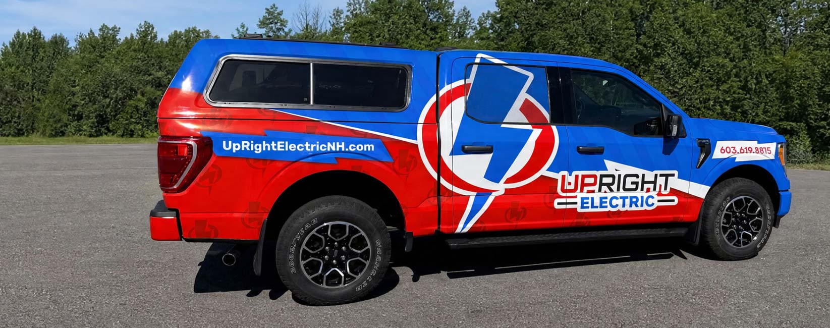 Upright Electric service truck parked beside trees